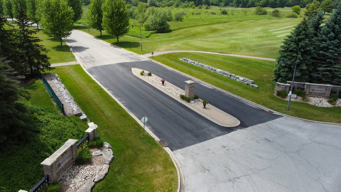 Completed asphalt entrance and surrounding property