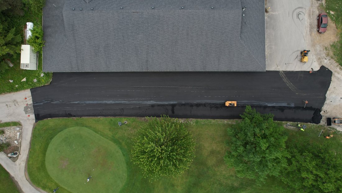 Top-down aerial view of paving progress